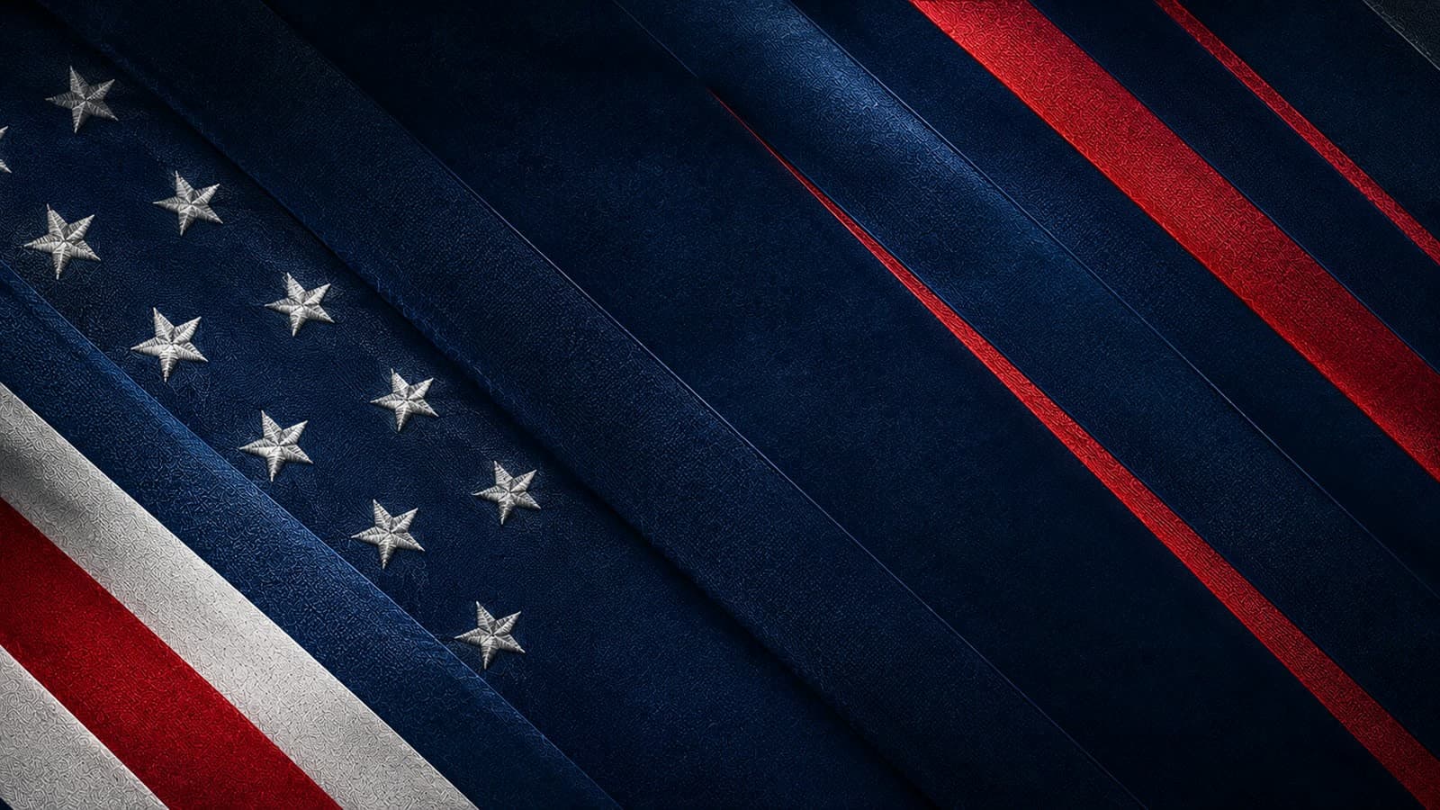 Close-up of a dark blue flag with embroidered white stars and red and white stripes running diagonally