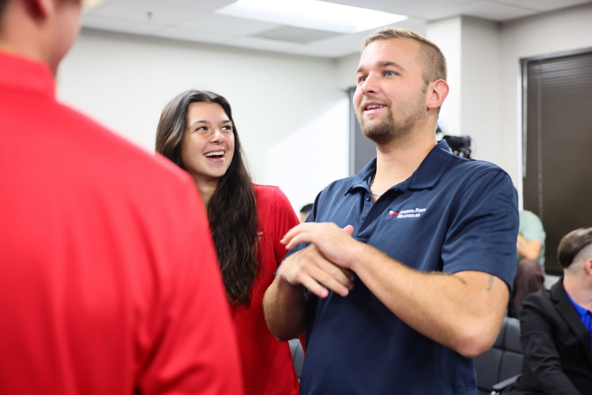 America First Healthcare team members talking in the office